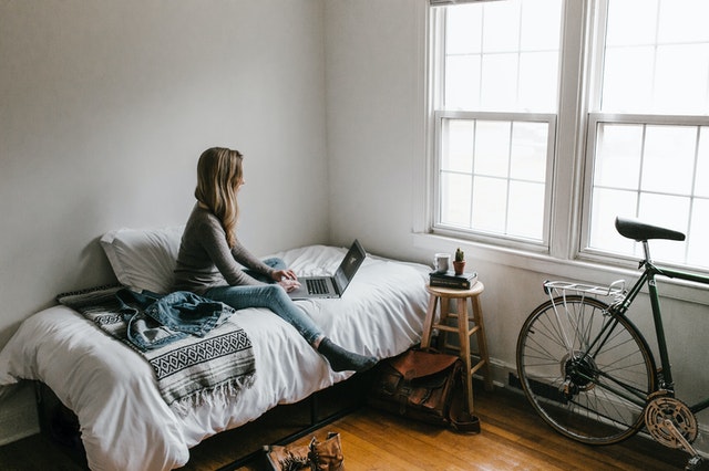 Woman In Gray Shirt Sitting On Bed 3954635